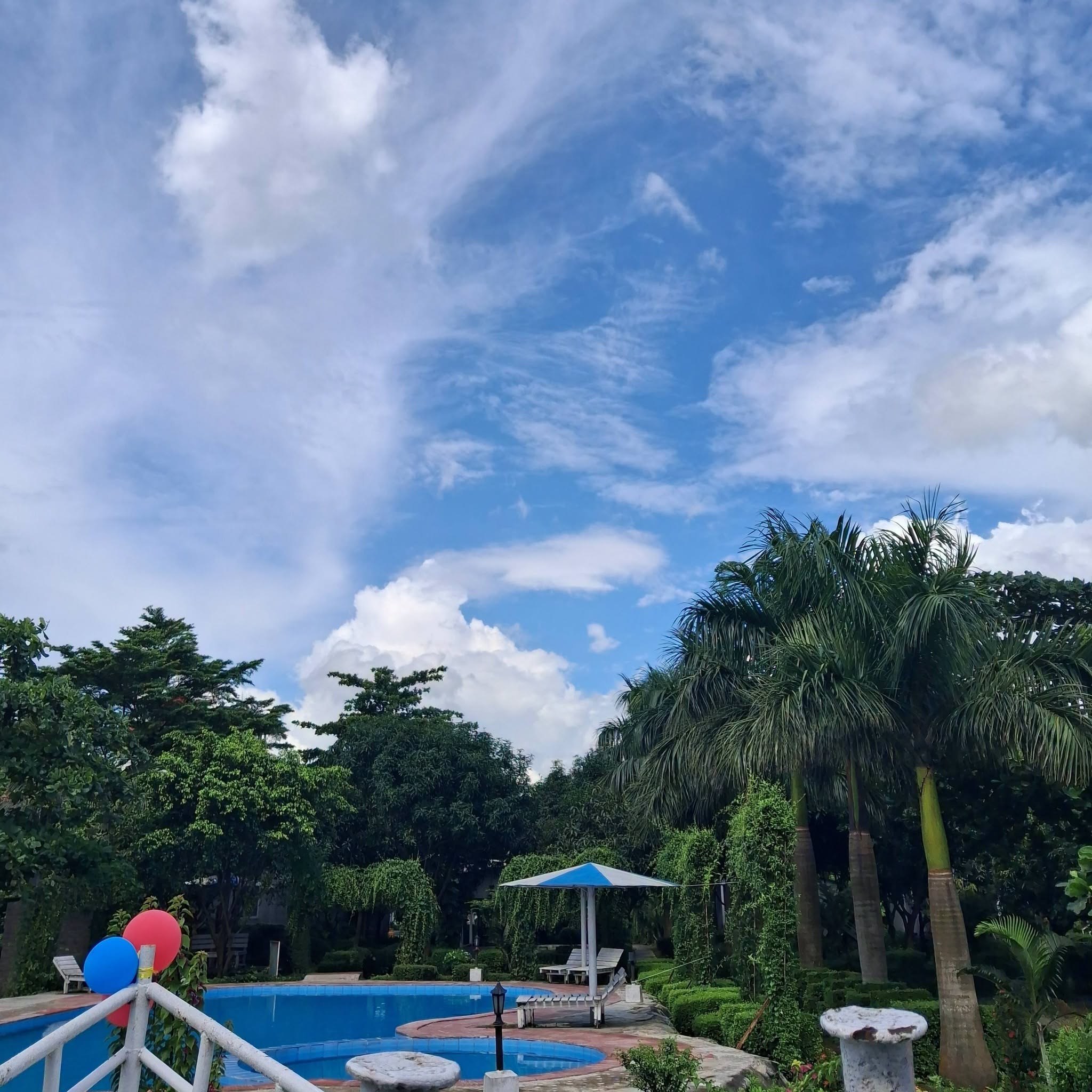 Resort pool and gardens where guests relax between the boat ride and the meal